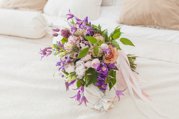 Bouquet of flowers on a pillow in bed.