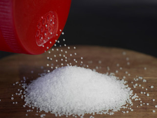 salt granules on wood with red salt