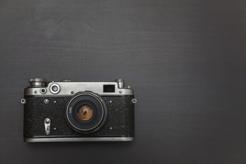 Vintage Film Camera On Black Wooden Background Technology Development Photographer Concept with...