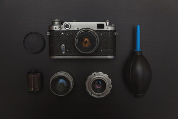 Vintage Film Camera And Accessories On Black Wooden Background Technology Development Concept. Top...