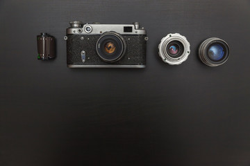 Vintage Film Camera And Accessories On Black Wooden Background Technology Development Concept with...