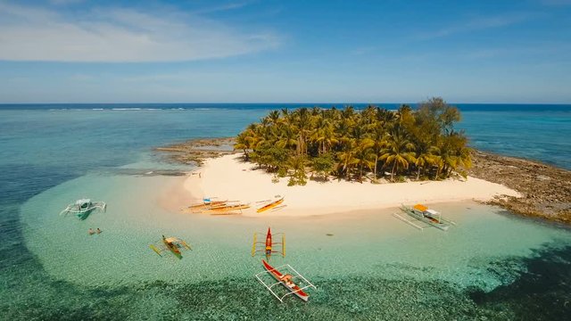 Aerial view of beautiful tropical island Guyam with white sand beach. View of a nice tropical beach from the air. Seascape: Ocean and beautiful beach paradise. Philippines. 4K video. Travel concept