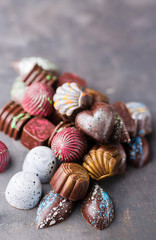 Fototapeta na wymiar Colored chocolate candies. Creative sweets on a gray background.