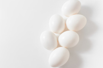 White eggs on a white background. Easter photo concept. Copy space. View from above.