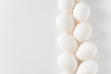 White eggs on a white background. Easter photo concept. Copy space. View from above.
