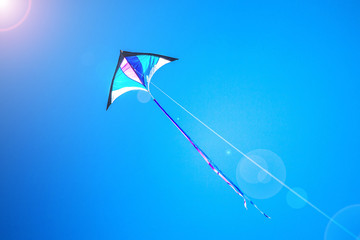 Triangle kite flying on a sunny day