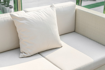 Rattan sofa seat with pillow in hotel or resort