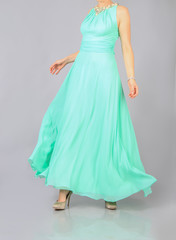 Fototapeta premium long green dress and clutch the girl in studio