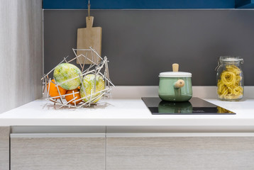 Stainless pot on modern black induction stove, cooker, hob or built in cooktop with ceramic top in...