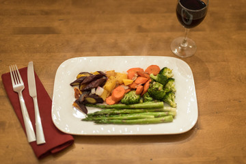 Vegetarian dinner of roasted seasonal veggies and red wine
