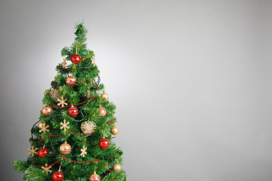 Christmas tree with decoration, grey background