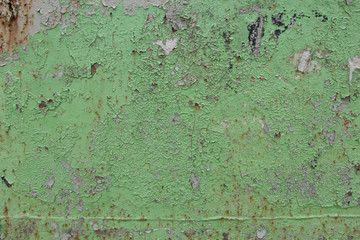 The texture of the cracked wall with the stucco plaster on the brick