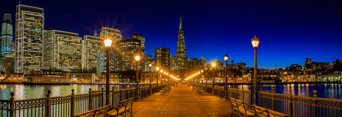 Downtown San Francisco and the Transamerica Pyramid at Christmas from wooden Pier 7 at sunset