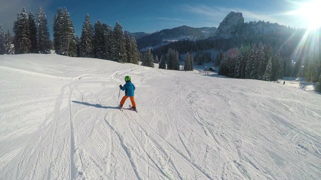 Happy little boy skiing in Alps
