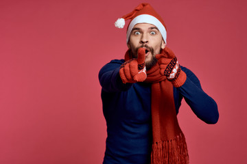 man pointing fingers forward, free space for copy, red background, new year