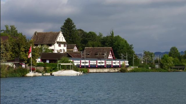 Swiss train passing Richterswil Rapperswil village on lake Zurich Zürichsee in Switzerland