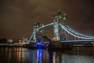 London / UK - 18 November 2017: Tower Bridge at night with lighting in cloudy sky