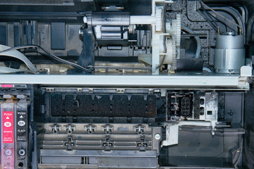 Old, dirty, disassembled ink jet printer. View of internal parts.