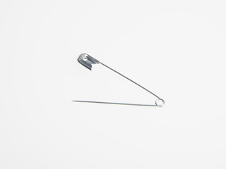 Pin or sewing safety pin on a background.