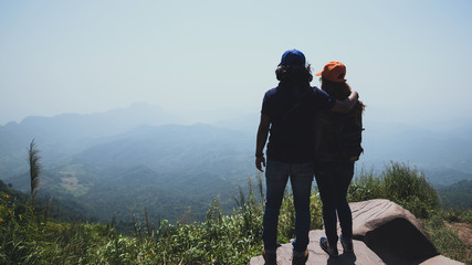 Lover women and men asians travel relax in the holiday. Stand up landscape on the Moutain. Mountain Park happily. In Thailand