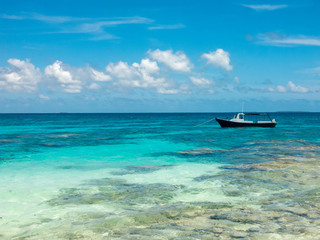 Boat anchored on shallow water