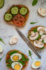 Ciabatta for breakfast. Sandwiches with arugula, egg, mushrooms, cucumbers and tomatoes