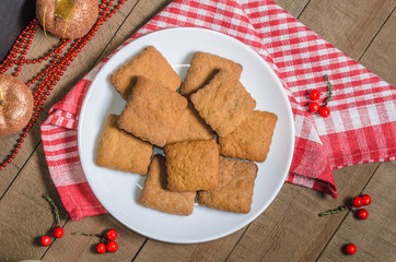Biscuits, milk, red napkin, Christmas decor with free space for text. Top view