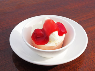 Strawberry mousse cake in white bowl on wooden table