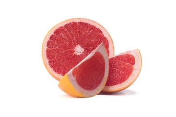 Naklejka na ściany i meble The grapefruit is cut into three pieces and lies on a white background