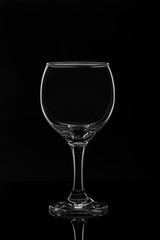 Empty wine glass on black background