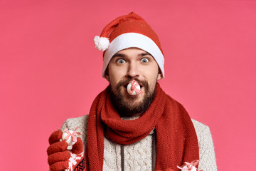 a man holds a Christmas decoration in his mouth, a new year, a holiday