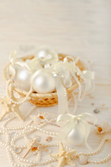 Fototapeta na wymiar Christmas and New Year. Christmas-tree white toys in a marine style, seashells stones and starfish.