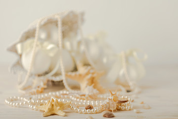 Fototapeta na wymiar Christmas and New Year. Christmas-tree white toys in a marine style, seashells stones and starfish.