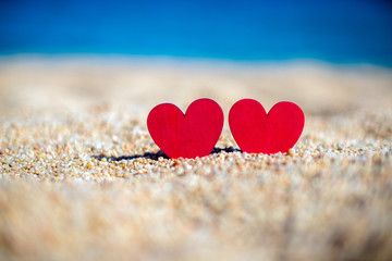 Fototapeta premium romantic symbol of two hearts on the beach 