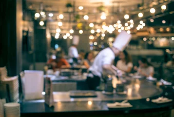 Foto op Plexiglas Koken Blur chef cooking in restaurant with  customer