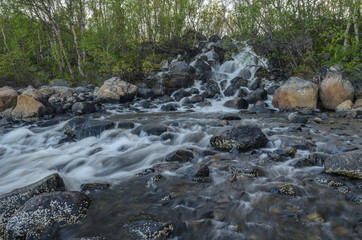 Waterfall,black stones ,summer.