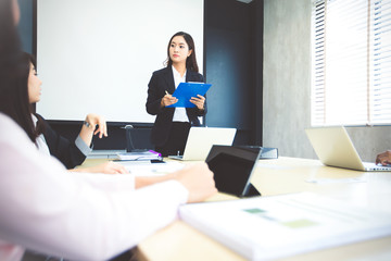 Asian businessmen and group using notebook for meeting serious about the work