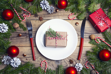 Festive table setting with cutlery and Christmas decorations on wooden table. Top view.