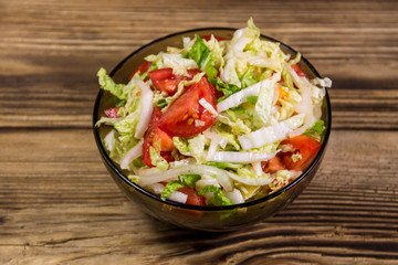 Fresh vegetable salad on wooden table