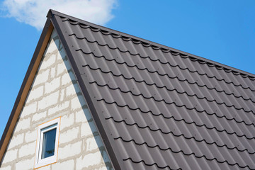 Roof of the house under brown shingles