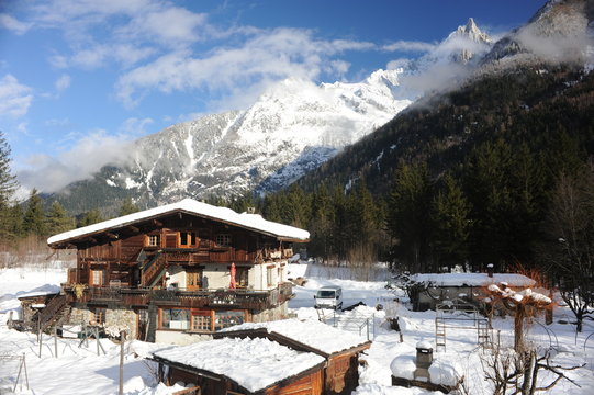 Chalet in French Alps in Chamonix with a panorama of mountains covered in snow in winter