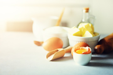 Baking background. Cooking ingredients for dough, eggs, flour, sugar, butter, rolling pin on white style kitchen. Copy space