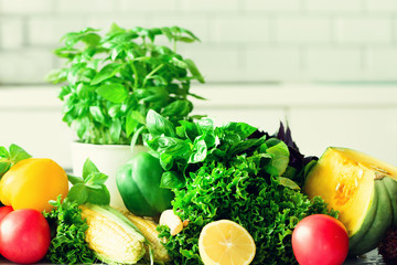 Woman peeling pumpking, vegetables, onion, tomatoes, corn, bell pepper, spinach, lettuce leaves. Clean eating, detox concept