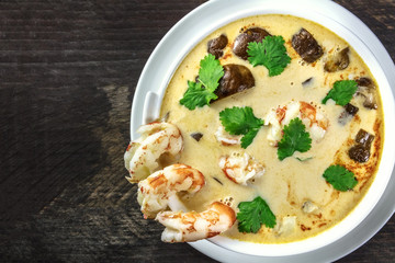 Tom Yam, traditional Thai soup with shrimps and mushrooms, closeup