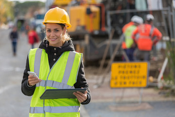 female construction woman using electronics on construction site