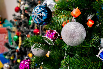 Decorated Christmas tree with colorful bauble on sparkling bokeh light blurred background