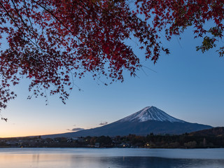 Fuji mountain with red maple and golden sunshine in the morning time of autumn.