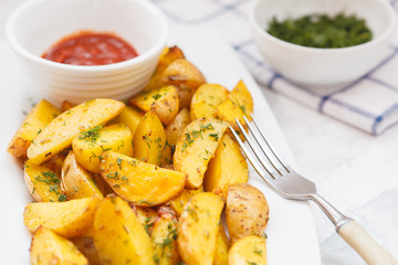 Baked potato slices with herbs in a white dish