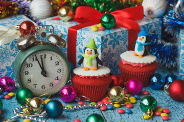 Christmas cupcakes with colored decorations penguins made from confectionery mastic