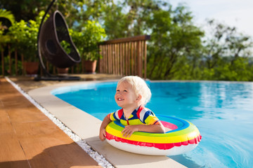 Baby in swimming pool. Kids swim. Child summer fun.